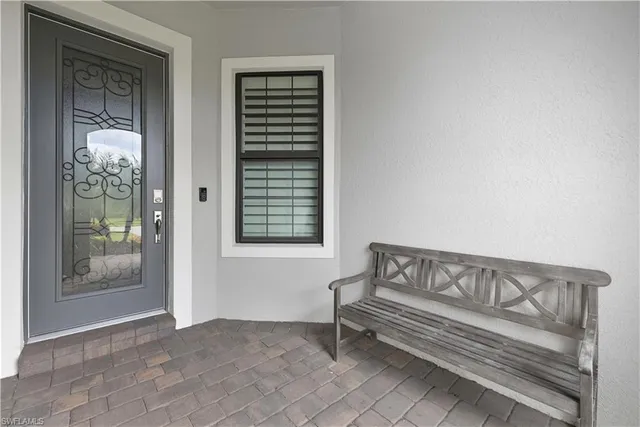 a view of a bedroom with furniture and windows