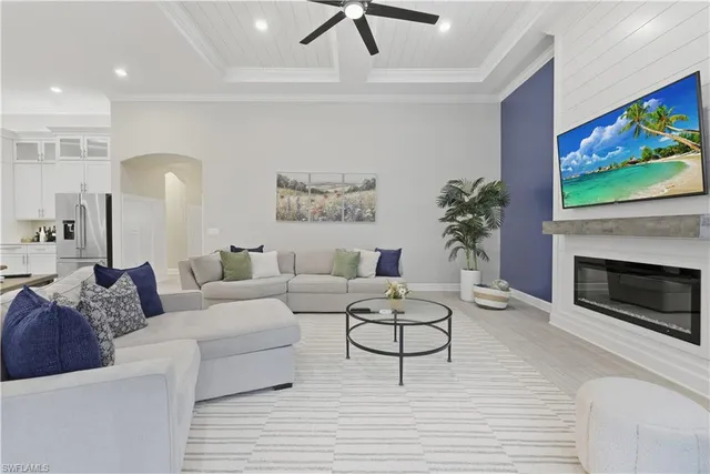 a living room with furniture a fireplace and a flat screen tv