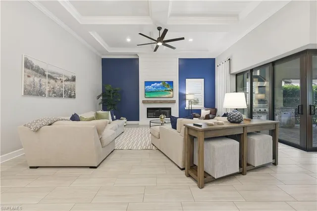a living room with fireplace furniture and a chandelier