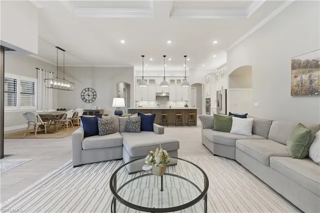 a living room with furniture and a chandelier