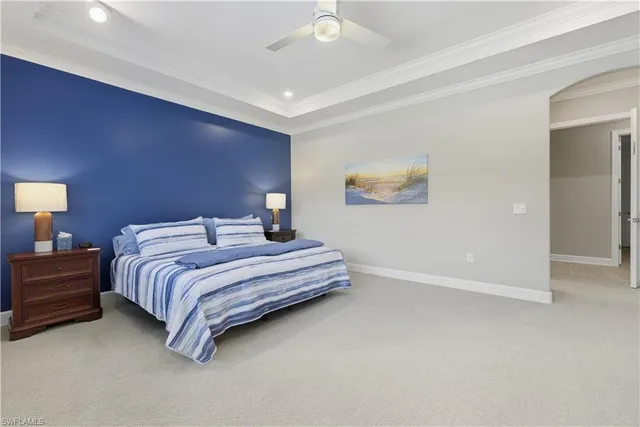 a bedroom with bed and a chandelier