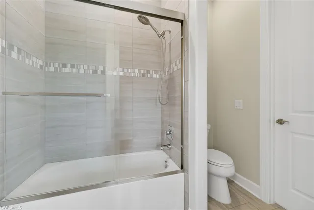 a bathroom with a bathtub and a toilet