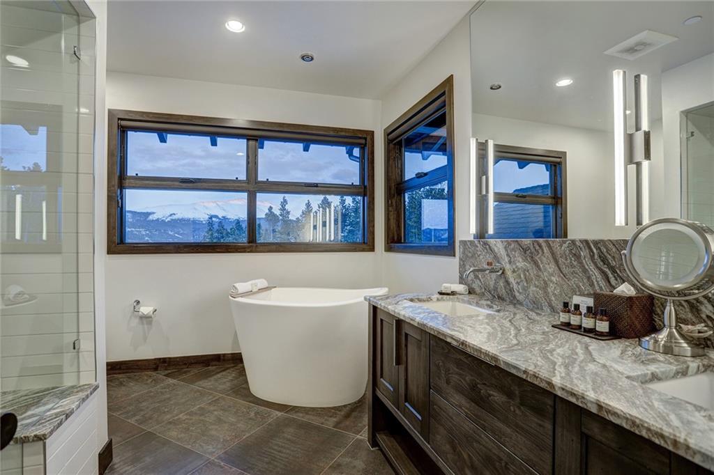 460 Timbertrail Road Breckenridge, CO 80424 - Photo 22 of 35 a bathroom with a granite countertop sink and a large mirror