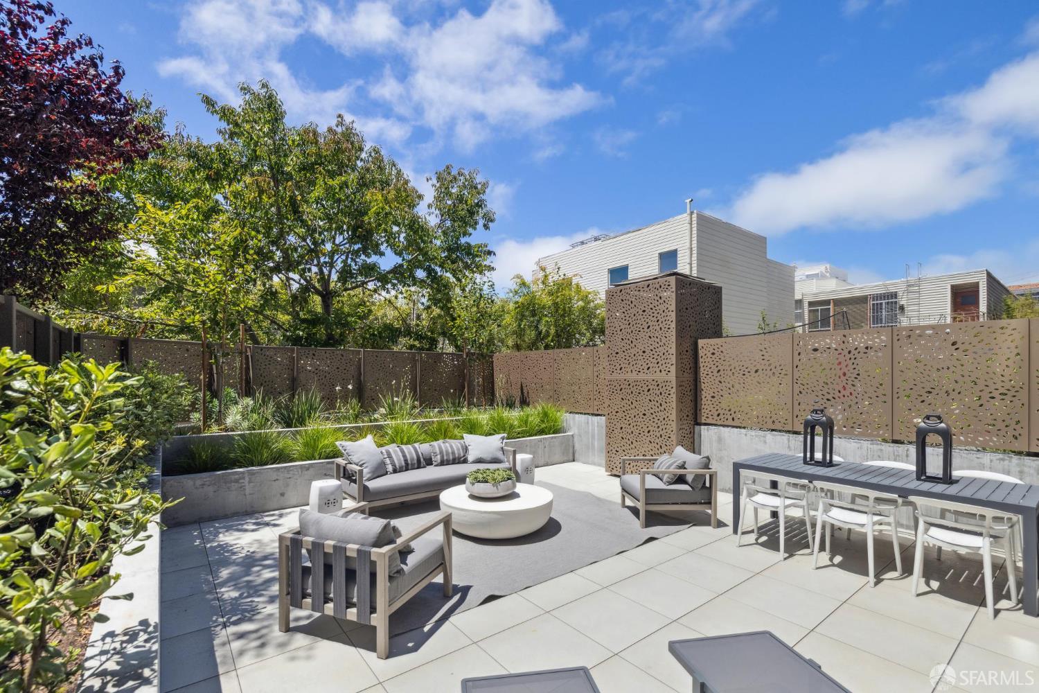 a view of a patio with couches table and chairs and potted plants