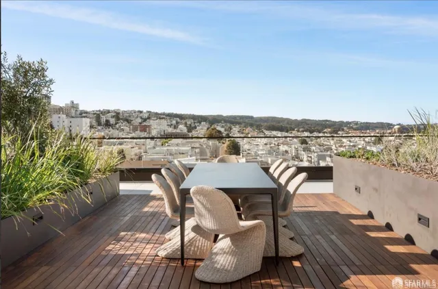 a view of a chairs and table in the balcony