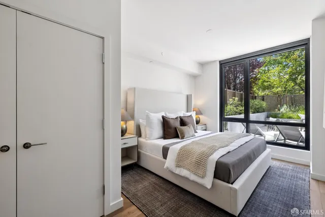 a bedroom with a bed lamp and window