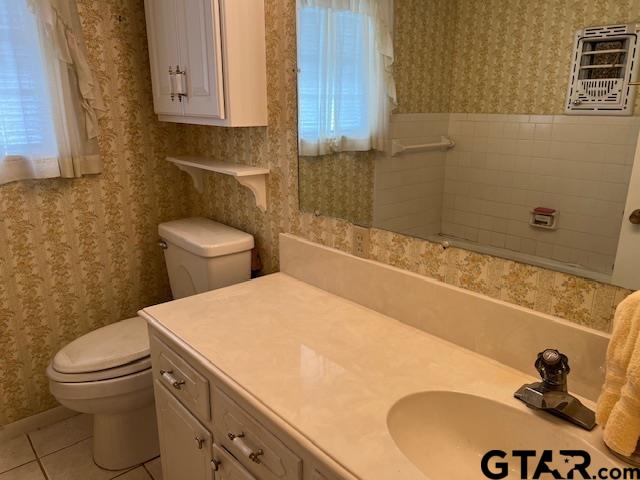 216 Arch Davis Road Pittsburg, TX 75686 - Photo 14 of 20 a bathroom with a sink a toilet and a mirror