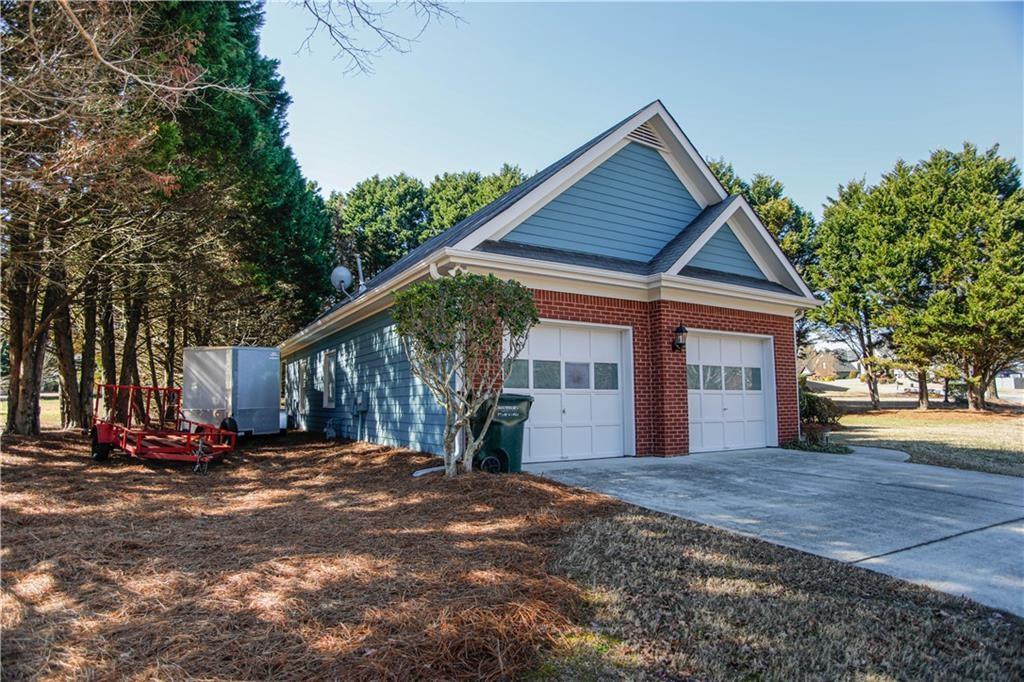 3875 Spring Manor Court Loganville, GA 30052 - Photo 2 of 23 a view of a house with backyard and trees