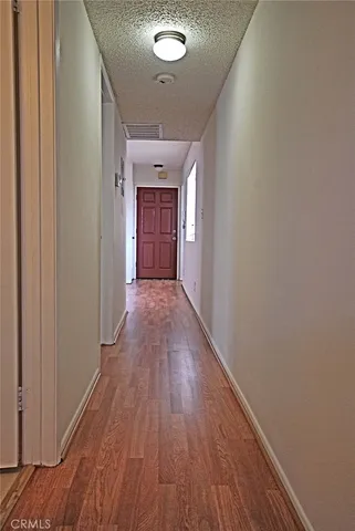 a view of gallery with wooden floor