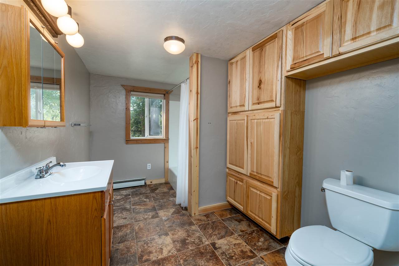 2052 I Road Fruita, CO 81521 - Photo 18 of 31 a bathroom with a granite countertop toilet and a sink