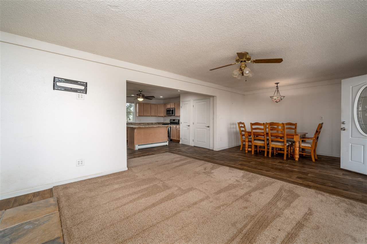 2052 I Road Fruita, CO 81521 - Photo 24 of 31 a living room with furniture and a chandelier