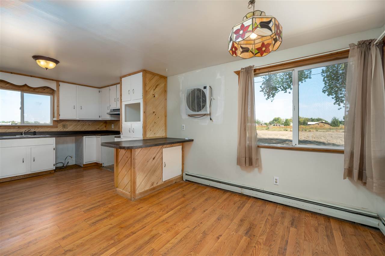 2052 I Road Fruita, CO 81521 - Photo 26 of 31 a kitchen with stainless steel appliances granite countertop a stove a sink and a large window