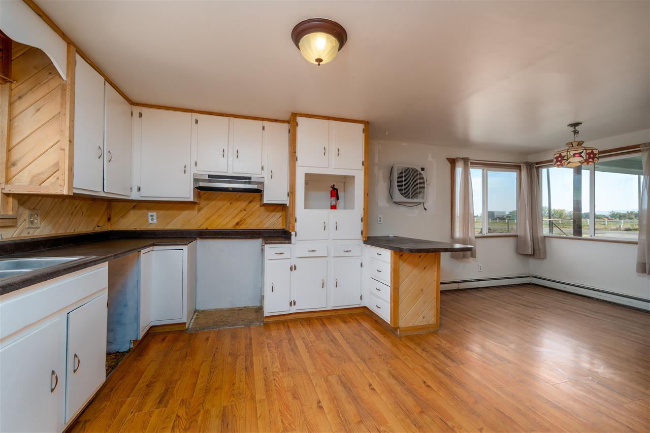 2052 I Road Fruita, CO 81521 - Photo 28 of 31 a kitchen with lot of cabinets and wooden floor
