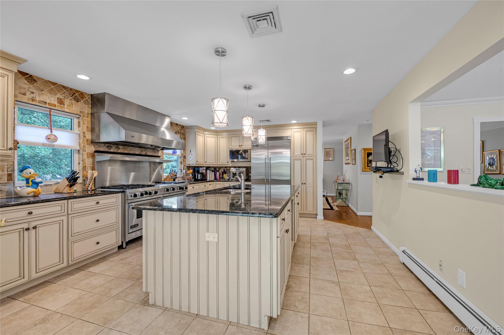 17 Melody Lane Bayville, NY 11709 - Photo 11 of 26 a kitchen with stainless steel appliances kitchen island granite countertop a sink and cabinets