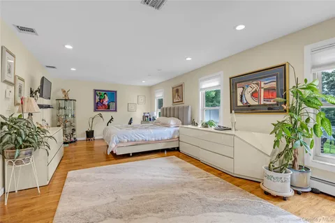 a spacious bedroom with a bed and a couch