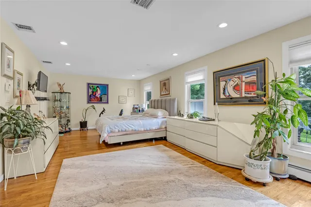 a spacious bedroom with a bed and a couch