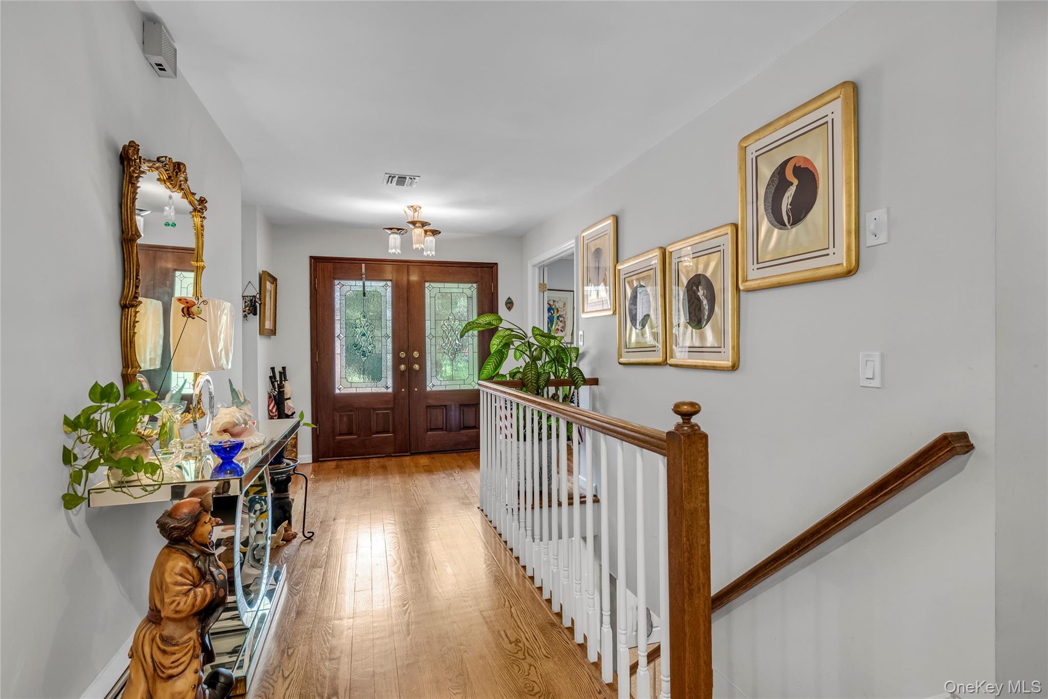 17 Melody Lane Bayville, NY 11709 - Photo 16 of 26 a view of entryway with wooden floor and stairs