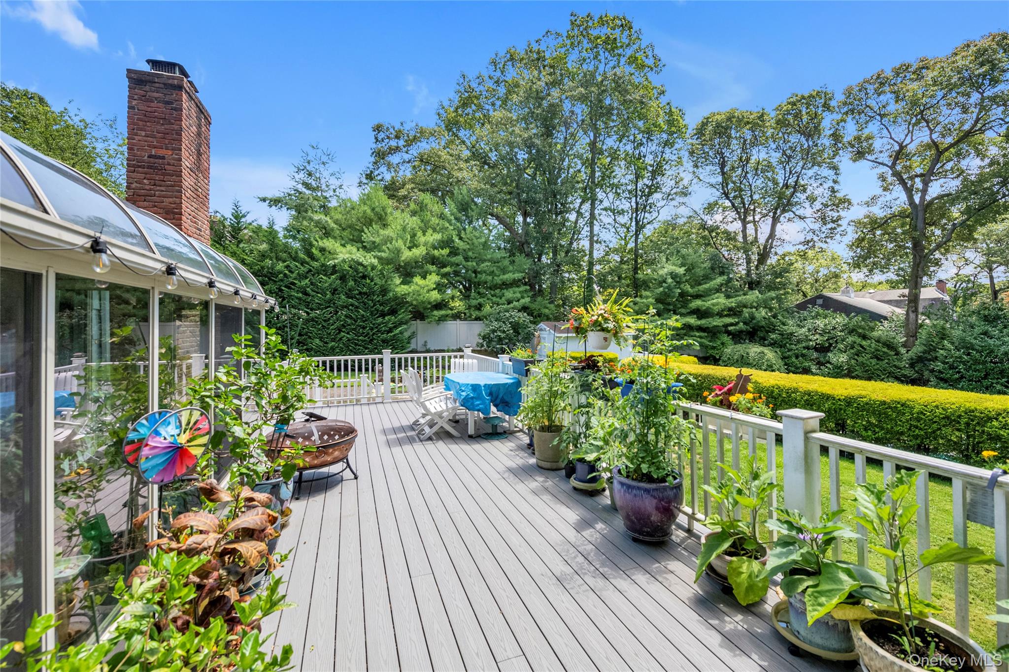17 Melody Lane Bayville, NY 11709 - Photo 17 of 26 a view of a chair and table on the wooden deck