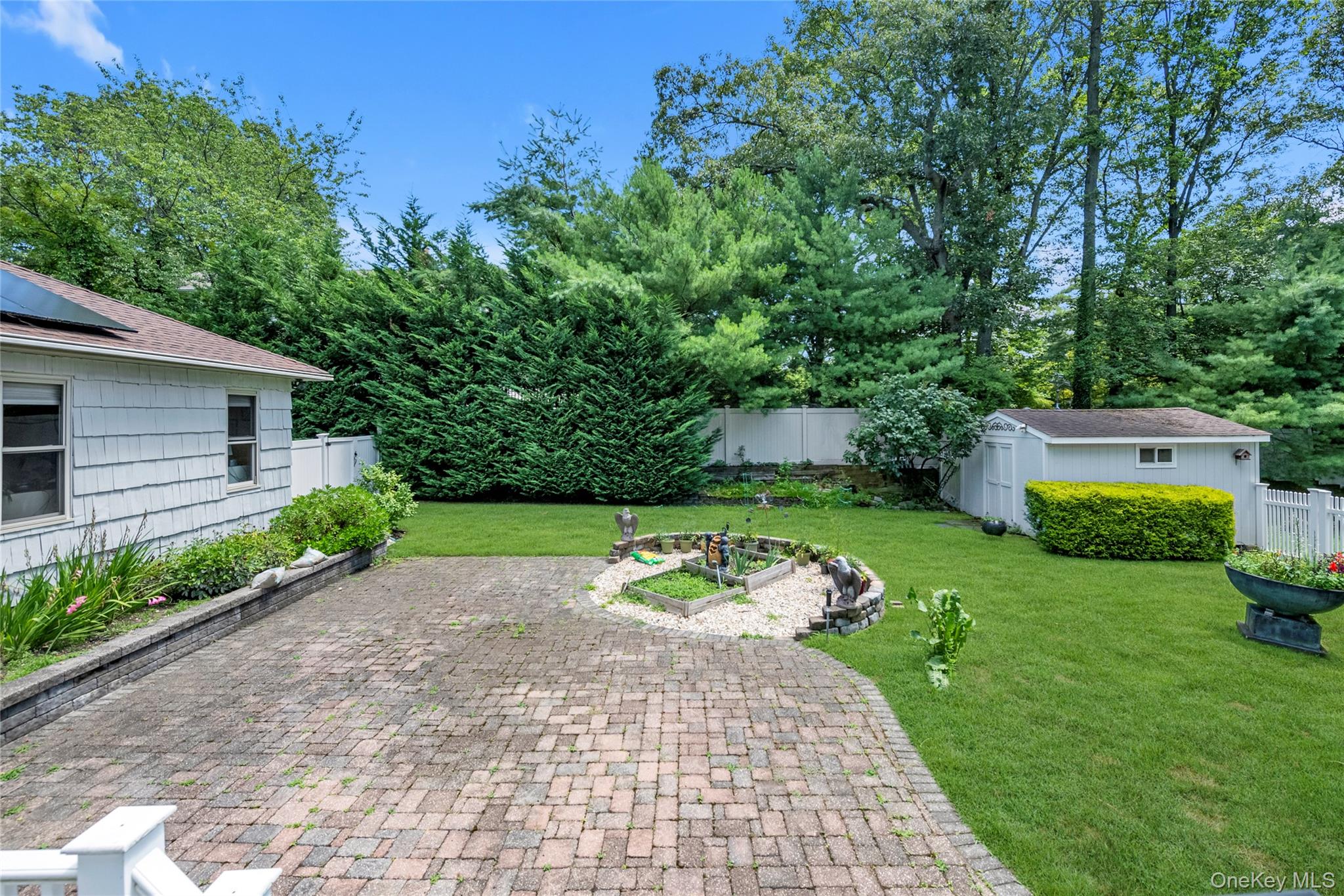 17 Melody Lane Bayville, NY 11709 - Photo 20 of 26 a view of a garden with a bench