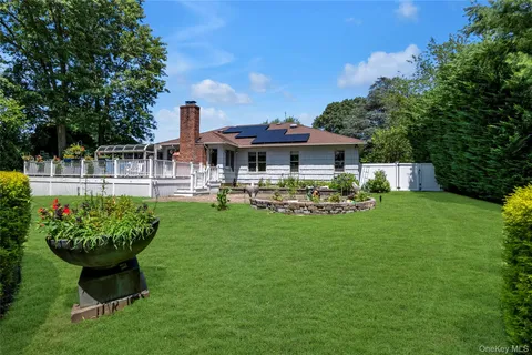 a front view of a house with a yard table and chairs
