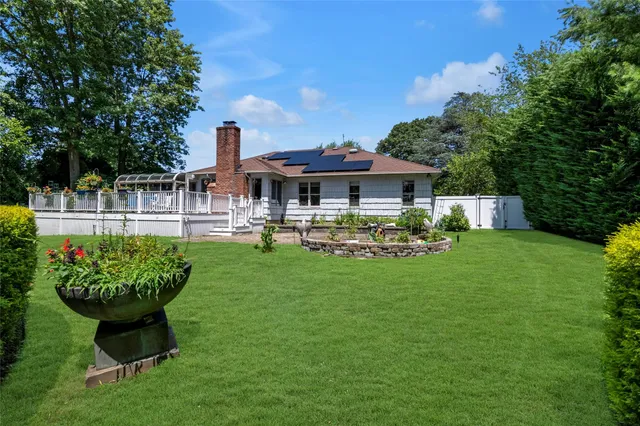 a front view of a house with a yard table and chairs