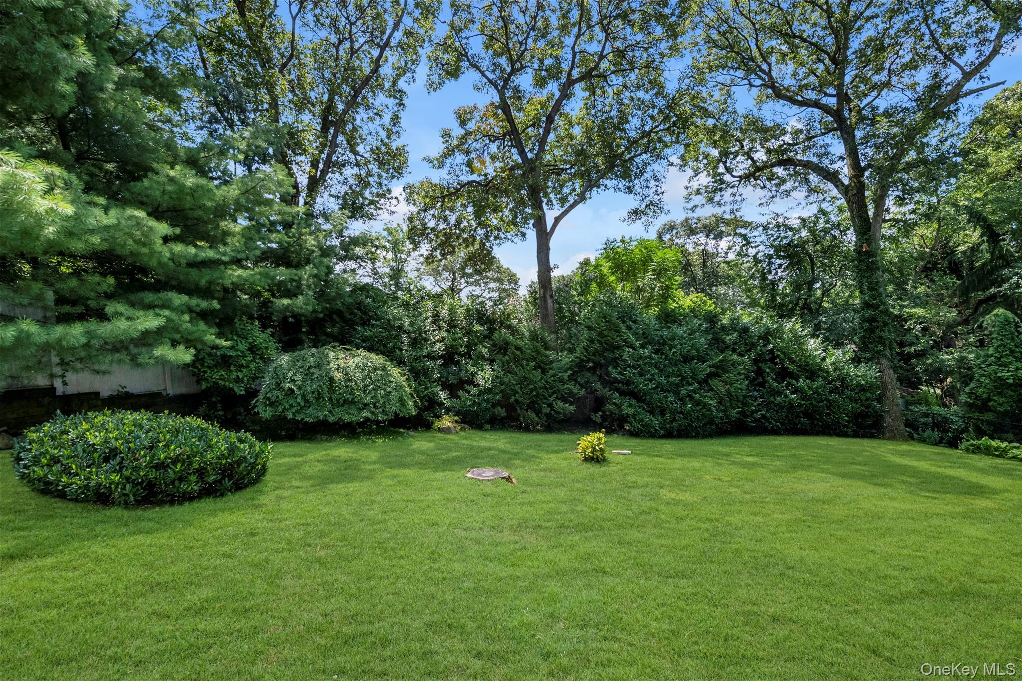17 Melody Lane Bayville, NY 11709 - Photo 5 of 26 a view of a green field with lots of bushes