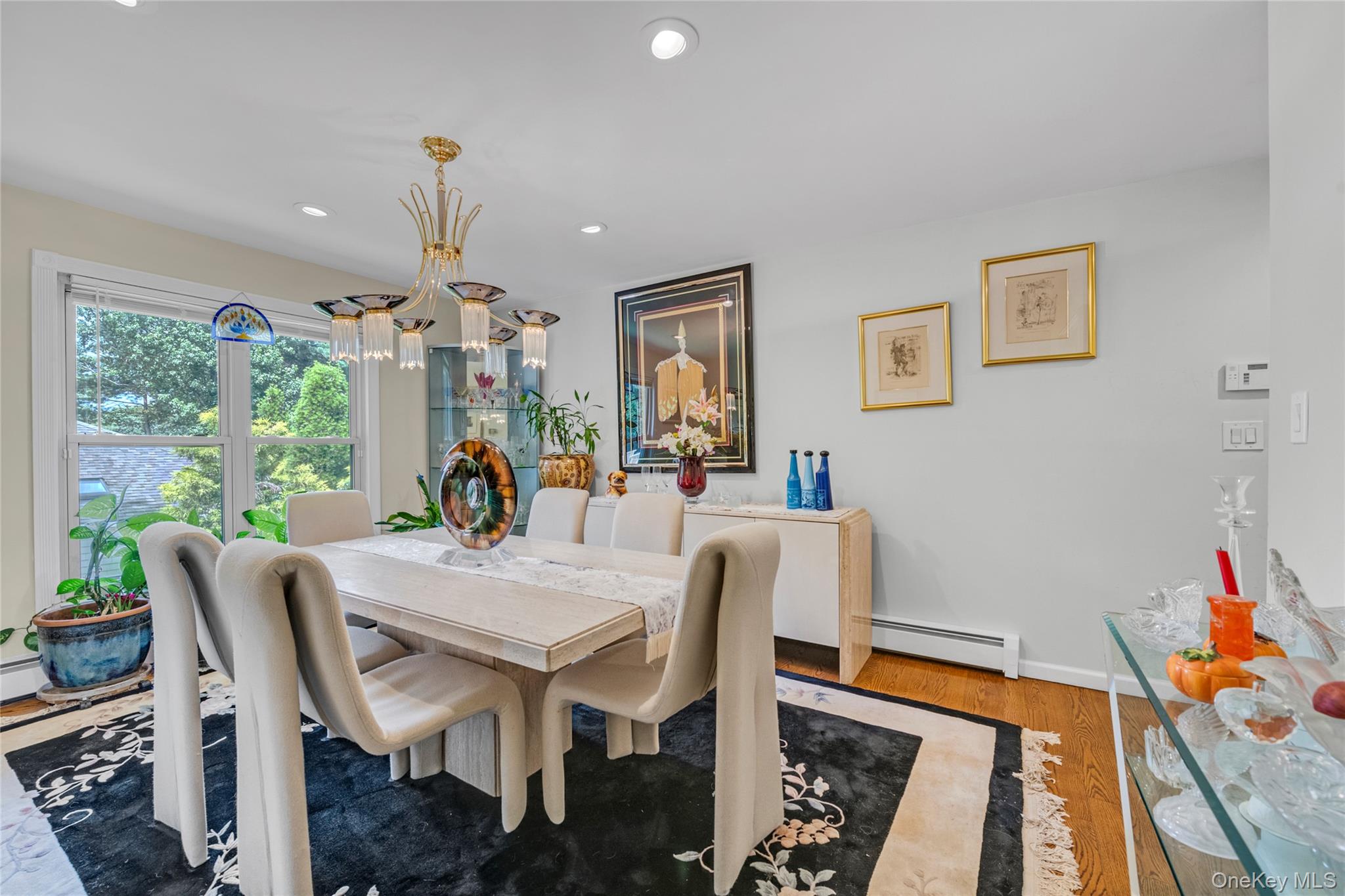 17 Melody Lane Bayville, NY 11709 - Photo 9 of 26 a view of a dining room with furniture a chandelier and wooden floor