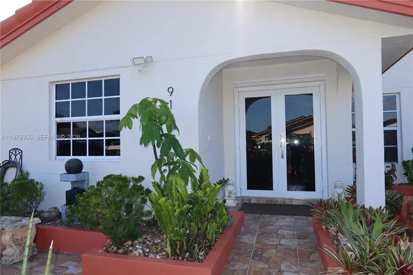 a vase with flowers sitting on front of it