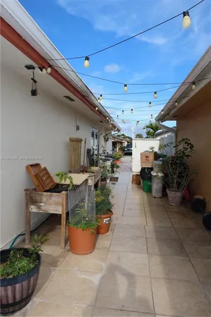 a view of a porch with furniture and plants