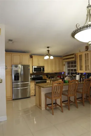 a kitchen with a sink and a refrigerator