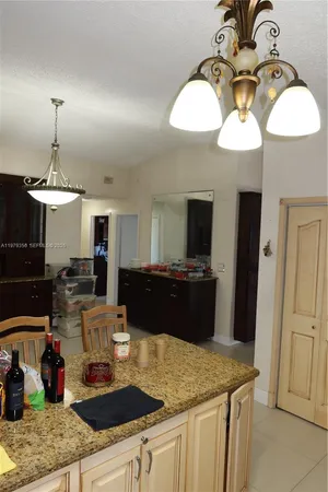 a living room with a couch a dining table and a fireplace