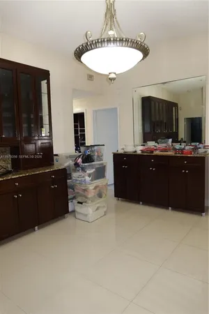 a white toilet sitting next to a bathroom sink and a shower