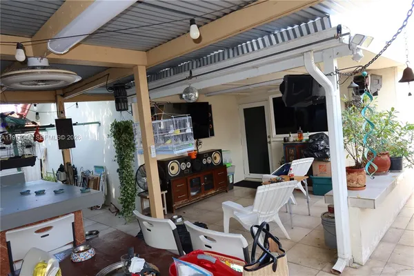 a large kitchen with stainless steel appliances a sink a stove and a refrigerator