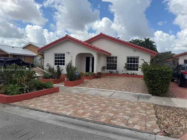 a view of house with garden and entertaining space