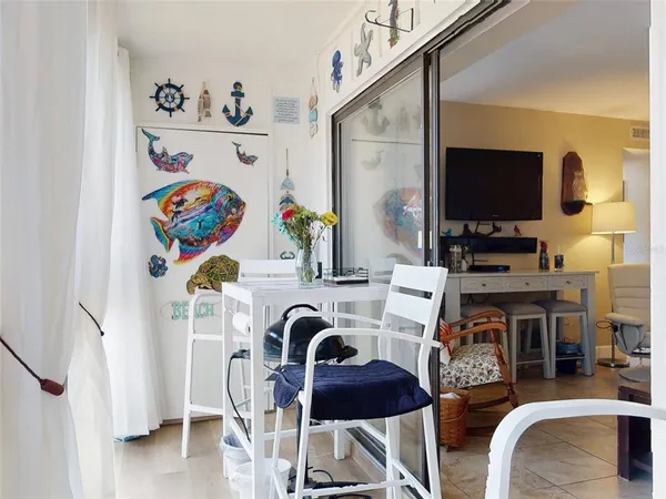 a room with furniture a chandelier and a window