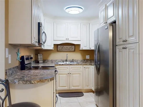 a kitchen with stainless steel appliances granite countertop a stove and a microwave