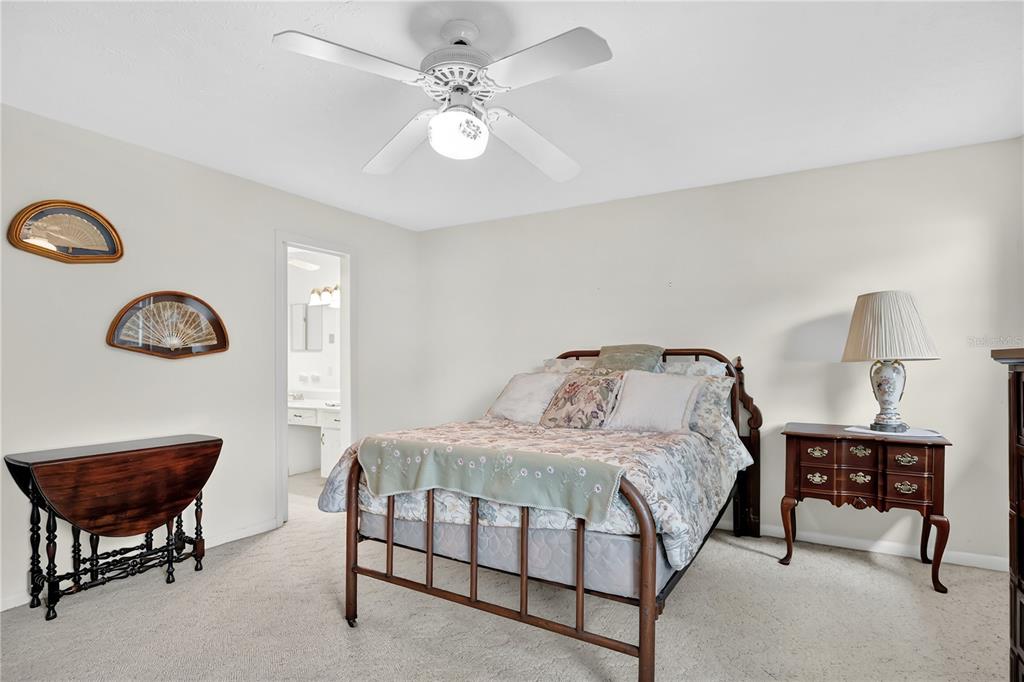 4262 Lake Underhill Road, Unit 9C7 Orlando, FL 32803 - Photo 14 of 22 a bedroom with a bed a chair and a chandelier