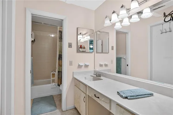 a bathroom with a sink vanity granite and a mirror