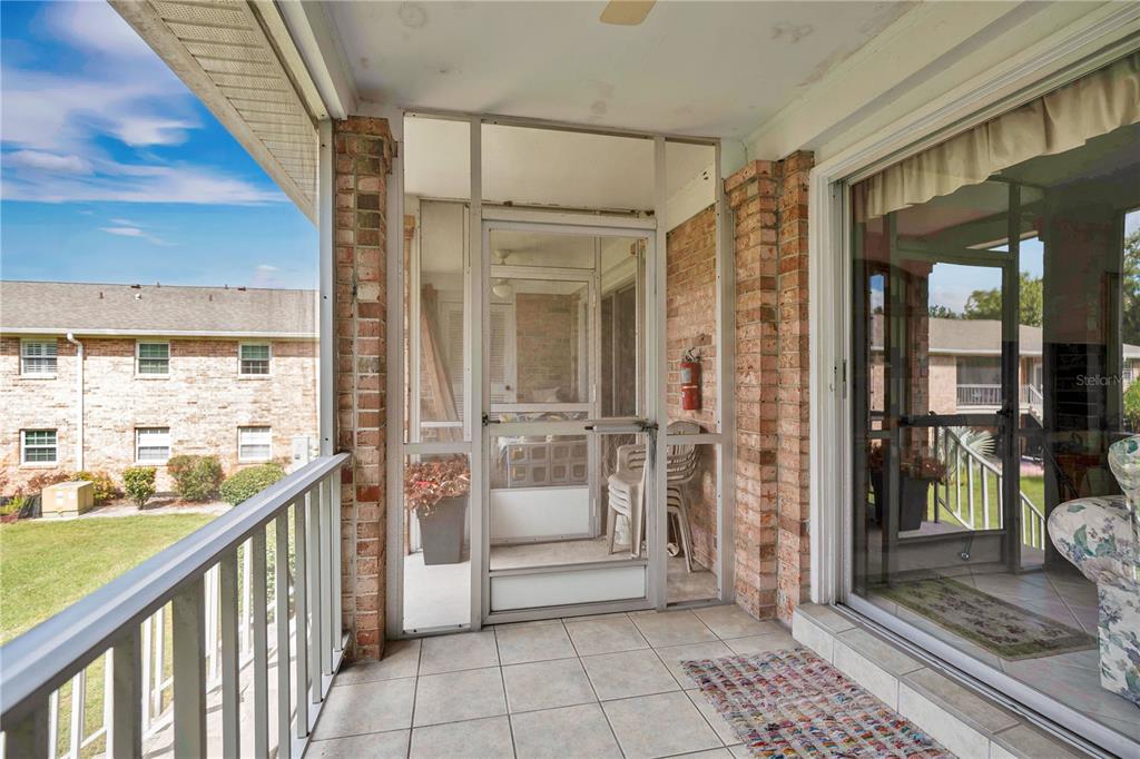 4262 Lake Underhill Road, Unit 9C7 Orlando, FL 32803 - Photo 20 of 22 a view of a balcony with wooden floor and furniture