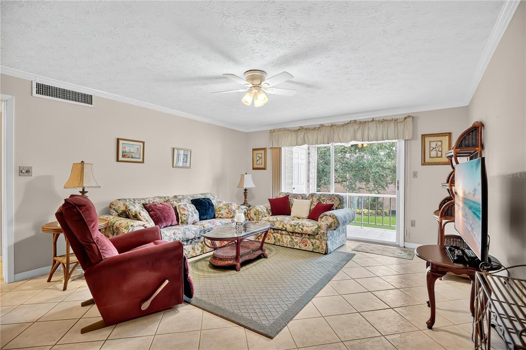 4262 Lake Underhill Road, Unit 9C7 Orlando, FL 32803 - Photo 4 of 22 a living room with furniture and a window