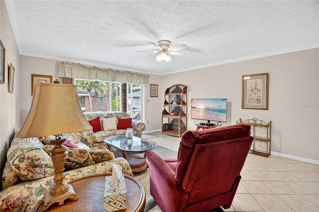 4262 Lake Underhill Road, Unit 9C7 Orlando, FL 32803 - Photo 5 of 22 a living room with furniture and a wooden floor
