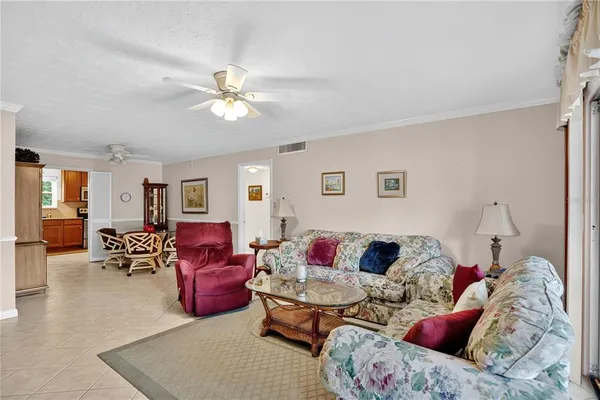 a living room with furniture ceiling fan and a rug
