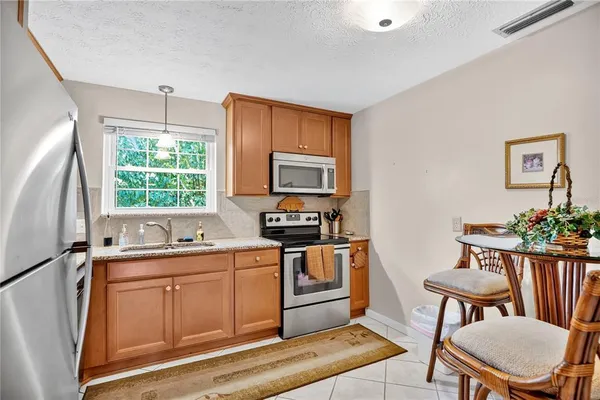 a kitchen with a sink stove and microwave