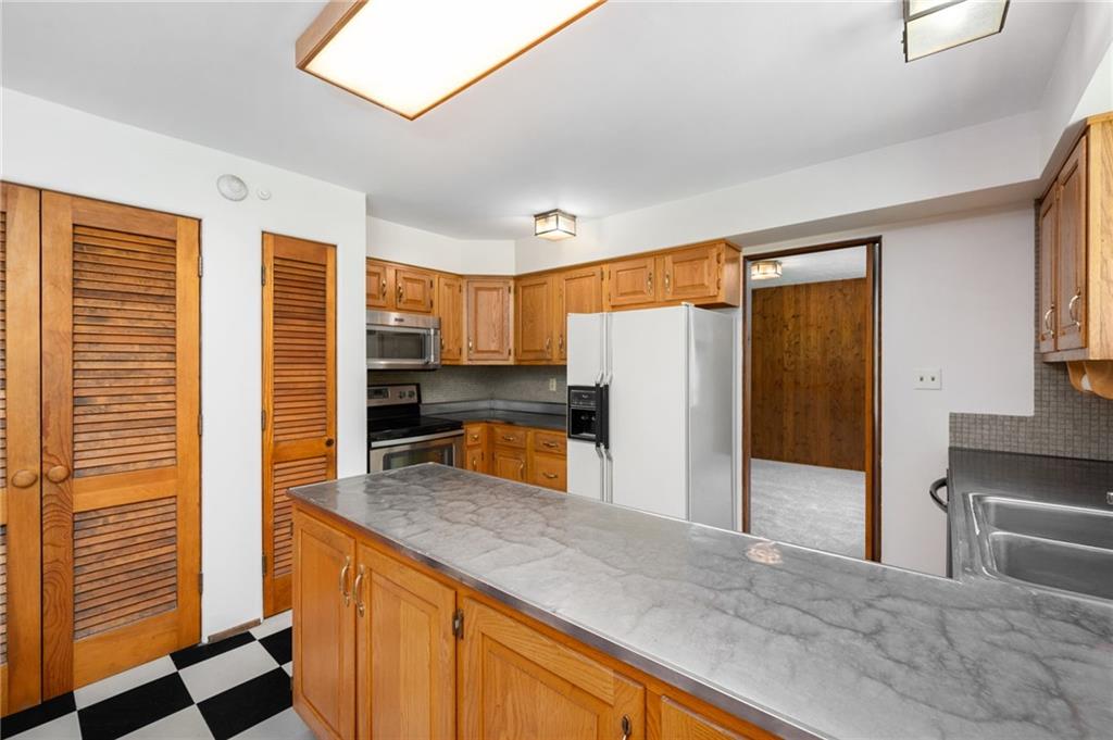 113 Iron Bridge Road Sarver, PA 16055 - Photo 16 of 49 a kitchen with stainless steel appliances granite countertop a refrigerator and a stove top oven