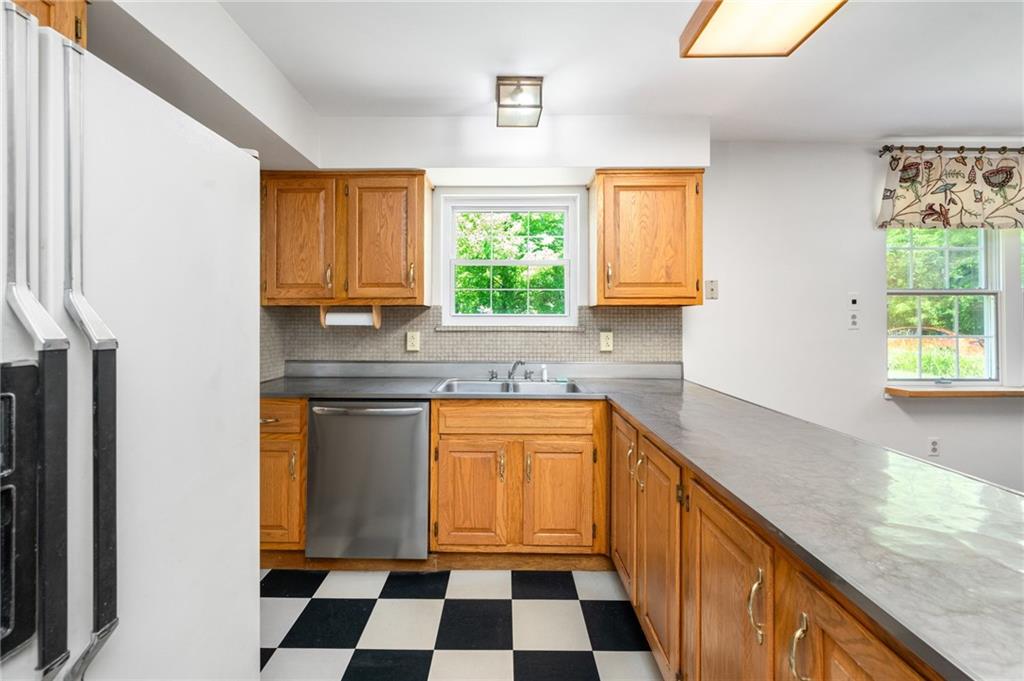 113 Iron Bridge Road Sarver, PA 16055 - Photo 17 of 49 a kitchen with a refrigerator a sink and a window