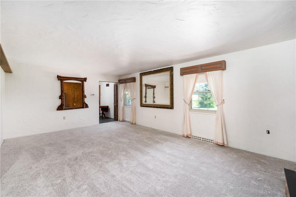 113 Iron Bridge Road Sarver, PA 16055 - Photo 22 of 49 an empty room with windows and an entrance to other room