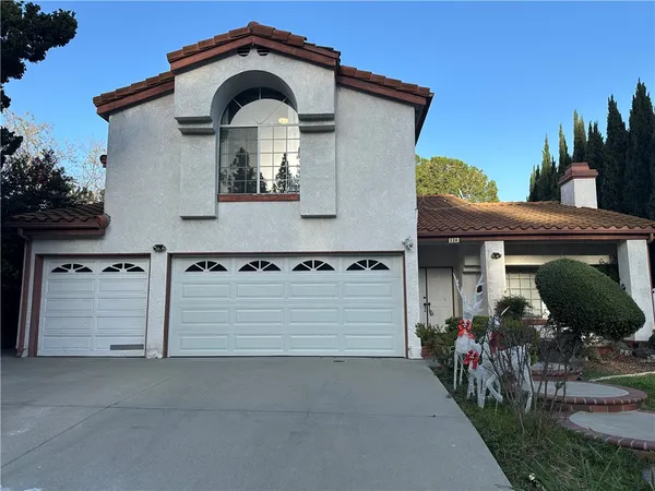 a front view of a house with garage