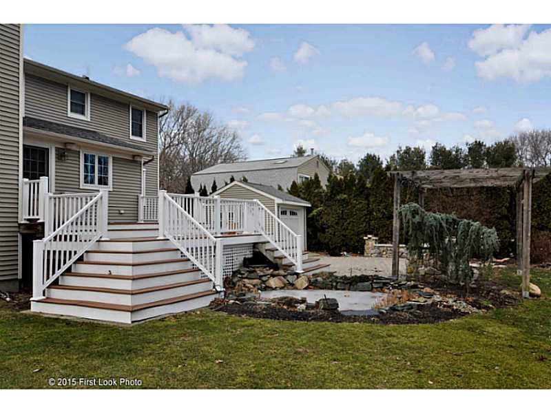 3 Deer Run Cranston, RI 02921 - Photo 23 of 25 Exterior Back. LOVELY YARD TO ENTERTAIN; OUTDDOR SPEAKERS, STAINLESS GRILL STATION, DECK AND PATIO. EVEN A LOI POND!!
