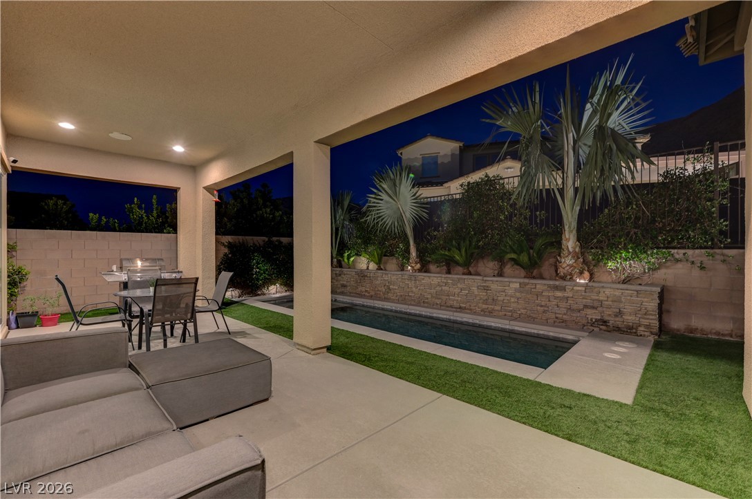 3943 Reyes Avenue Las Vegas, NV 89141 - Photo 93 of 95 An inviting covered patio with a built-in BBQ grill provides the perfect space for outdoor entertaining by the pool.