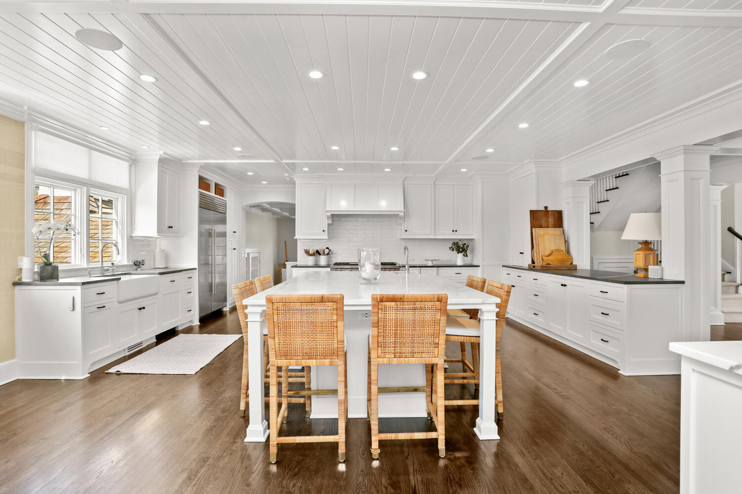 43 Contentment Island Road Darien, CT 06820 - Photo 17 of 59 a large kitchen with dining table chairs and wooden floor